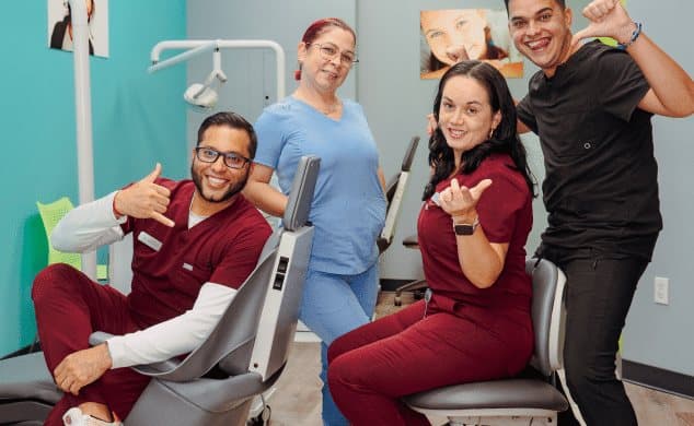 Vista Orthodontics team members smiling together in a treatment room