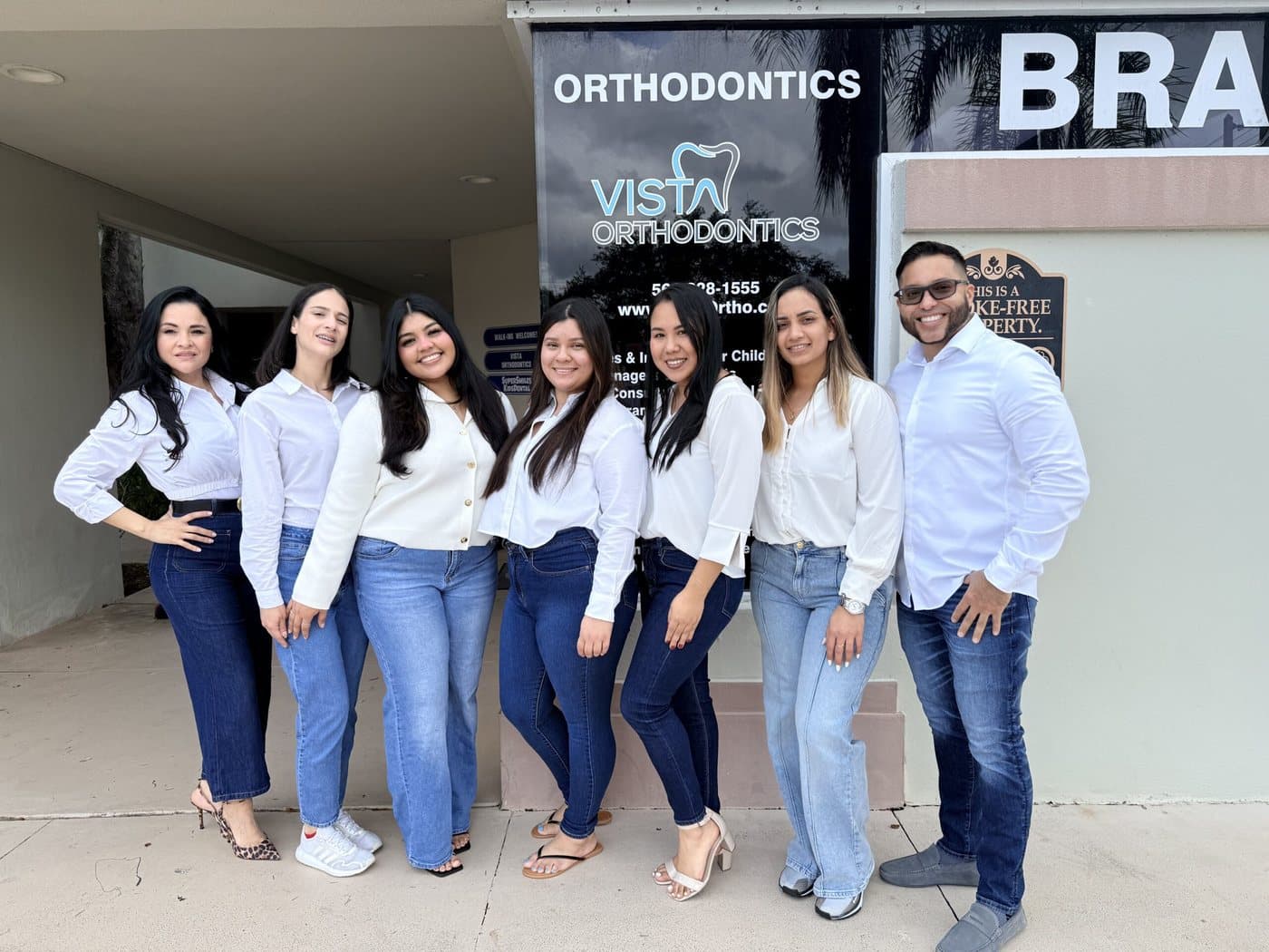 The Vista Orthodontics team standing together outside one of the practice's offices